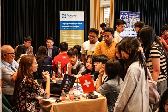 Students gathered around an institution booth speaking with representatives at the Superstar Education Fair 2026 Jakarta